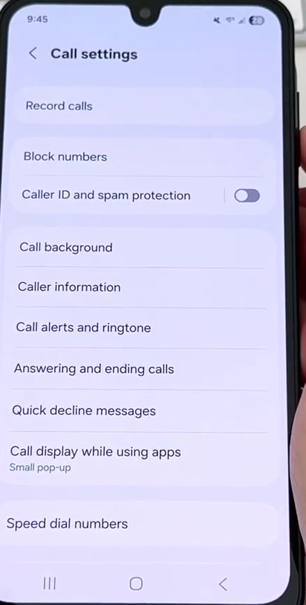 Samsung Call settings screen with Caller ID and spam protection listed below Block numbers, its toggle switched off