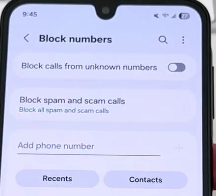 Samsung Block numbers screen showing the Block calls from unknown numbers toggle switched off and an Add phone number field