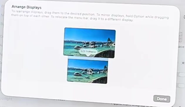 Arrange Displays sheet in macOS showing two screens stacked vertically