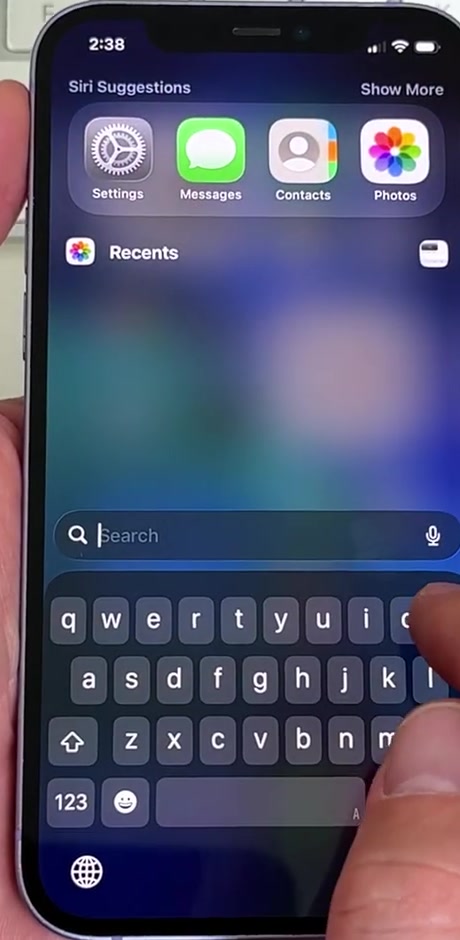 iPhone Search open with the keyboard showing, used to search for the Passwords app