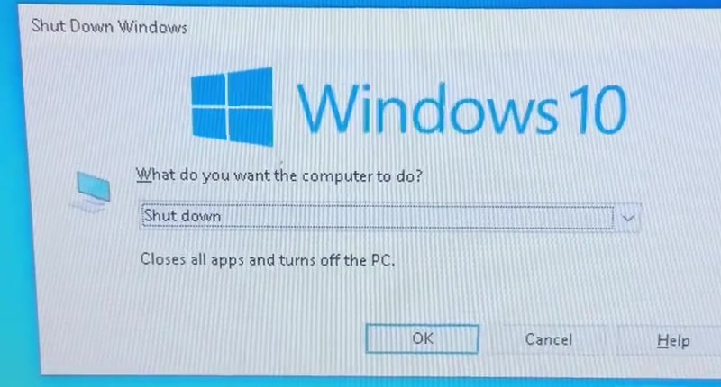 The Shut Down Windows dialog on a Dell laptop running Windows 10, with a drop-down currently set to Shut down and OK, Cancel and Help buttons