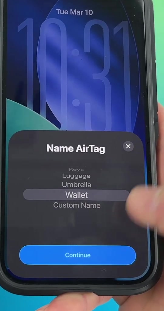 The Name AirTag picker scrolled to show Wallet selected, with Custom Name visible at the bottom of the list