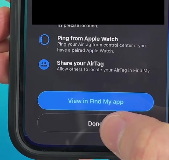 The final AirTag setup screen showing Ping from Apple Watch and Share your AirTag options above View in Find My app and Done buttons