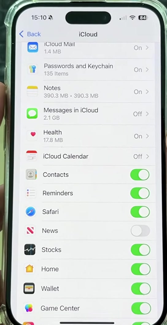 Lower part of the iCloud app list on iPhone showing Contacts, Reminders, Safari, News, Stocks, Home, Wallet and Game Center with green toggles