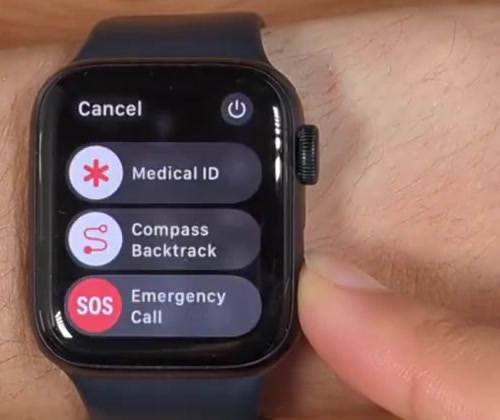 The Apple Watch sliders screen showing Medical ID, Compass Backtrack and Emergency Call, with a power icon in the top-right corner