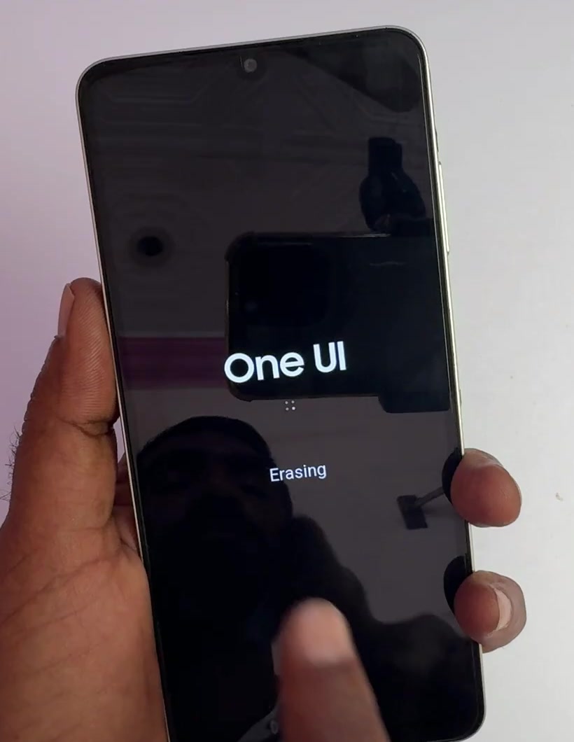 Samsung One UI startup screen showing Erasing while the factory reset runs