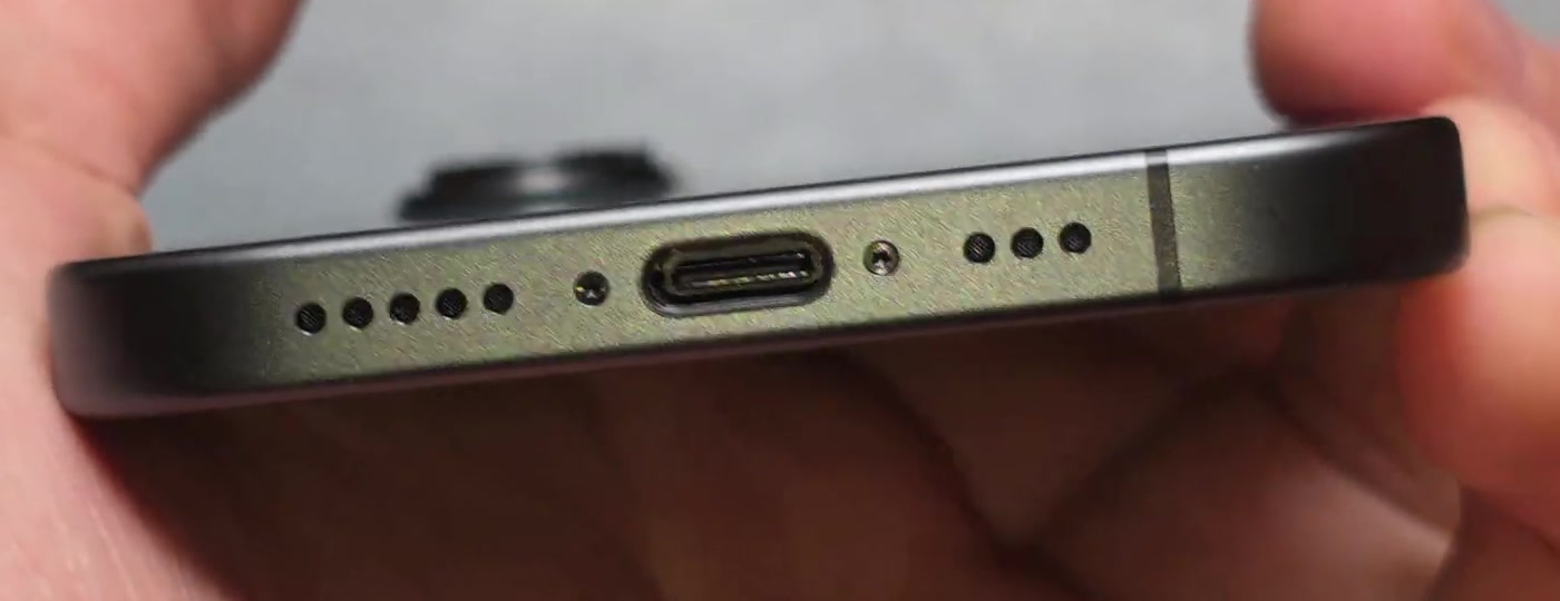 Close-up of the USB-C charging port on the bottom edge of an iPhone